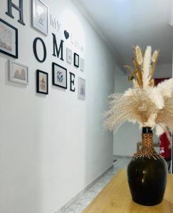 a black vase sitting on a table in a room at Sweet Home in Miranda do Douro