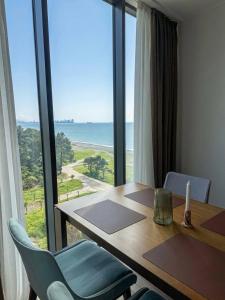 a table and chairs with a view of the ocean at Tropical Garden apart hotel in Batumi