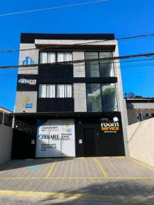 a building with a sign on the front of it at Campina Room Service in Campina Grande