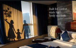 a bedroom with a window with a silhouette of a family at AH apartments in Rawalpindi