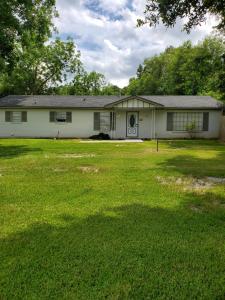 a house with a large lawn in front of it at Comfortable home in Mobile