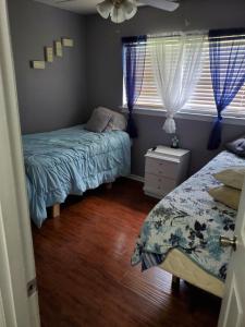 a bedroom with two beds and a window at Comfortable home in Mobile