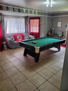 a living room with a pool table and a couch at Comfortable home in Mobile