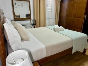 a bedroom with a bed with two towels on it at Sweet Home in Miranda do Douro