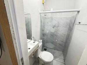 a bathroom with a toilet and a sink and a shower at Mini Ap no derby com Garagem in Sobral