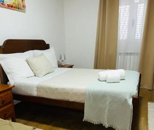 a bedroom with a bed with two towels on it at Sweet Home in Miranda do Douro +17 photos