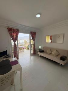 a living room with a couch and a table at Orlando Costa Adeje in Adeje