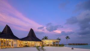a resort with a pool and a building at Centara Grand Lagoon Maldives - Free Round Trip Speedboat when stay 4 nights or more between 17 April - 15 October 2026 in North Male Atoll