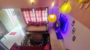 an overhead view of a room with a bed and purple lights at yercaud Happy valley cottage in Yercaud