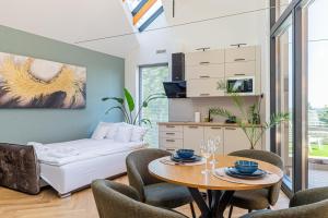 a living room with a table and chairs at Elite House Platina Apartment in Leányfalu