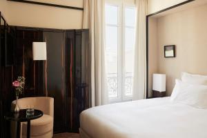 a hotel room with a bed and a window at Hôtel Atlas in Paris