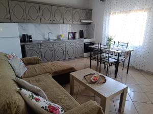 a living room with a couch and a table at Ioanna's Apartment in Potamiá
