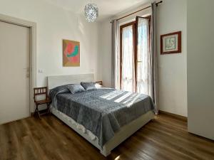 a bedroom with a bed and a large window at Ramoscello in Altare +20 photos