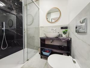 a bathroom with a toilet and a sink and a shower at Morski Raj Apartamenty in Dębki +29 photos