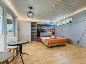 a bedroom with a bed and a desk and a table at Morski Raj Apartamenty in Dębki