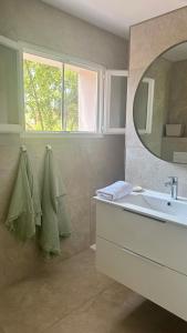 a bathroom with a sink and a mirror at l'Alzelle Plage in Biguglia +39 photos
