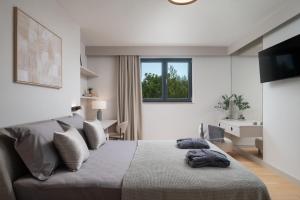 a white bedroom with a bed and a window at Villa DaEva in Drage
