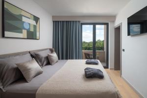 a bedroom with a bed with a bag on it at Villa DaEva in Drage +20 photos
