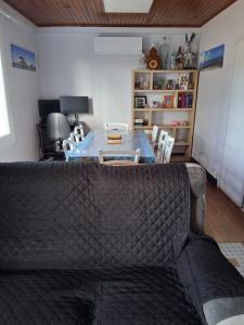 a living room with a couch and a table at Maison proche bassin et océan in Arès