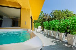 a swimming pool with a hot tub on a house at Elite House Gold Apartment in Leányfalu
