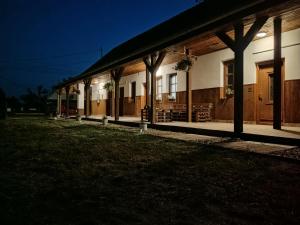 a house at night with the lights on at Luna Vendégház in Ipolyvece