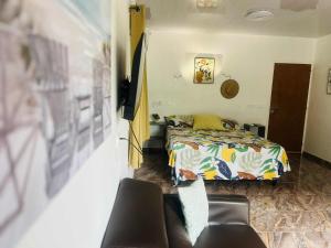a bedroom with a bed and a couch at Bungalow tatayo in Aua