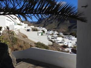 a view of a village with white buildings on a hill at Casa El Nido, Agaete in Agaete
