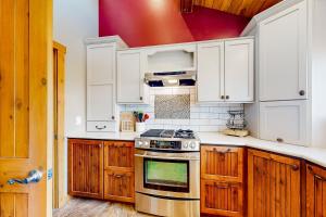 a kitchen with white cabinets and a stove top oven at Flagstaff Fantasy - Casita in Flagstaff