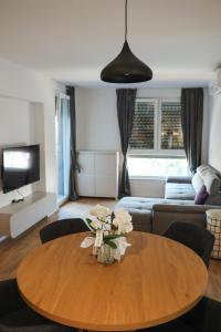 a living room with a table and a couch at MODERN ESCAPE apartment with garage in Split