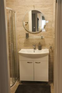 a bathroom with a sink and a mirror at MODERN ESCAPE apartment with garage in Split +18 photos