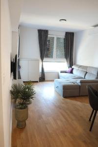 a living room with a couch and a table at MODERN ESCAPE apartment with garage in Split