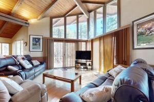 a living room with couches and a coffee table at Home in the Pines in Munds Park