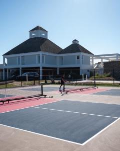 a man riding a skateboard on a tennis court at Z Breeze in Nags Head