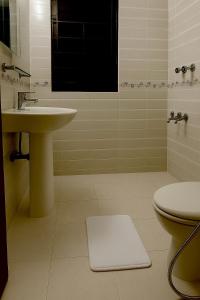 a bathroom with a sink and a toilet at Elegant Residence Guest House in Dhaka +11 photos