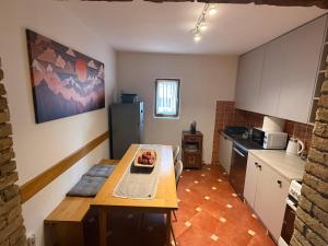 a small kitchen with a table in a room at Vila Rosa Kolasin in Kolašin +25 photos
