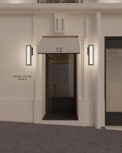 a room with a clock on the wall in a building at Hôtel Atlas in Paris +14 photos
