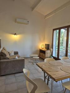 a living room with tables and chairs and a couch at Clos de Valamade in Cannes-et-Clairan