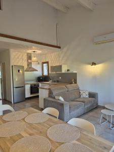a living room with a couch and a kitchen at Clos de Valamade in Cannes-et-Clairan