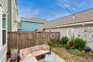 a backyard with a fence and a couch at Wander Bentonville in Bentonville