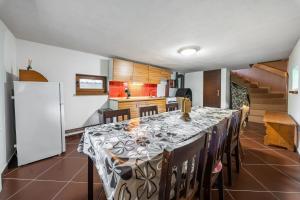 a dining room with a table and a kitchen at Horská chata ERIK in Levoča