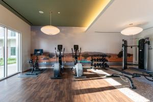 a gym with several treadmills and machines at Caravan Court Hotel in Arlington