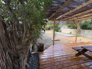 a wooden deck with a tree and a picnic table at CAEN ça repose ! in Caen +39 photos