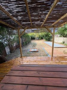 a patio with a wooden floor and a wooden roof at CAEN ça repose ! in Caen