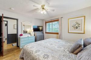 a bedroom with a bed with a blue dresser and a ceiling fan at Pinnacle 2101 in Beech Mountain +20 photos