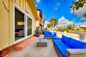 a row of blue couches on a balcony at Balboa Duplex in Newport Beach