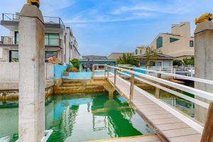 a bridge over a body of water with buildings at Balboa Blue Lagoon in Newport Beach