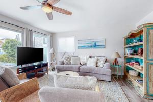 a living room with a couch and a flat screen tv at Balboa Blue Lagoon in Newport Beach +25 photos