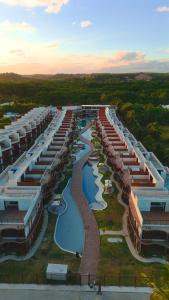 an aerial view of a large building with a river at NAAY - Nature 106 in Pôrto de Pedras