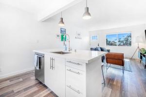 a kitchen with white cabinets and a sink at Aloha-Howdy Surf Gateway in San Clemente +27 photos