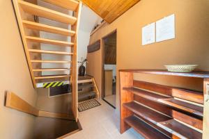 a kitchen with wooden shelves and a staircase at Horská chata ERIK in Levoča